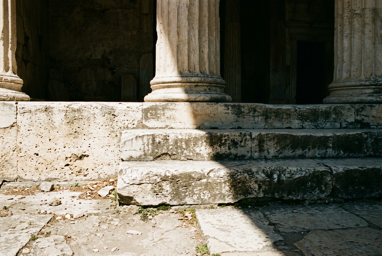 A classical stone relief fragment of figures in shadow under museum archival light
